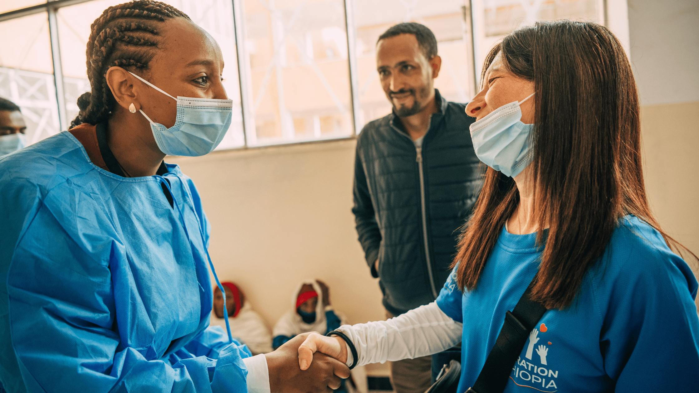 elisa hartstein shaking hands with ethiopian doctor