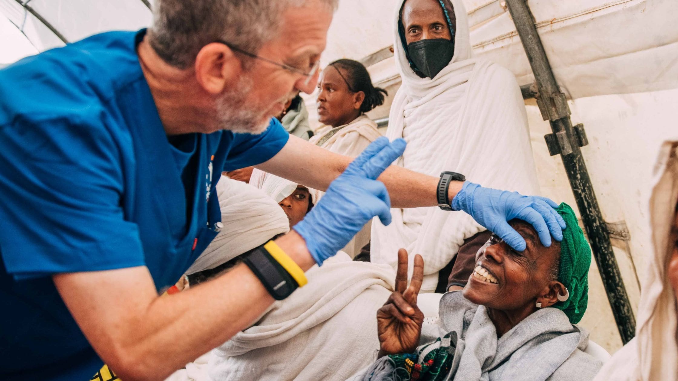 morris hartstein doing eye exam on elderly ethiopian woman