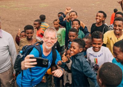 morris hartman taking selfie with group of ethiopian children