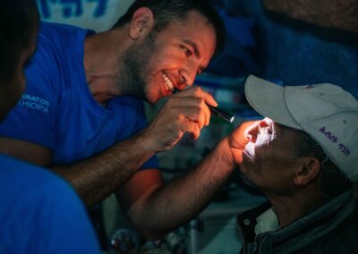 smiling operation ethiopia volunteer performing eye exam